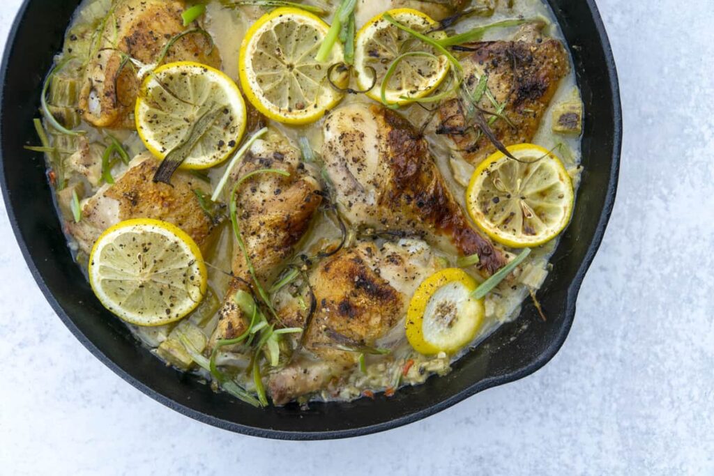 Cast iron skillet of rhubarb chicken with lemon