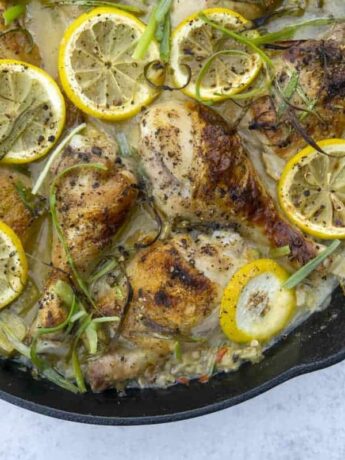 Cast iron skillet of rhubarb chicken with lemon