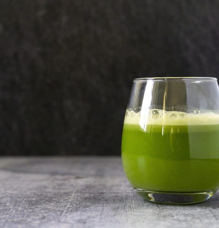 Foamy celery juice in a glass