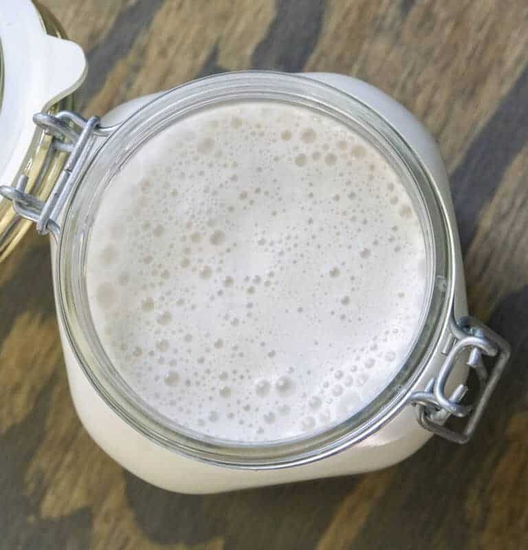 Overhead view of frothy Walnut milk in a mason jar