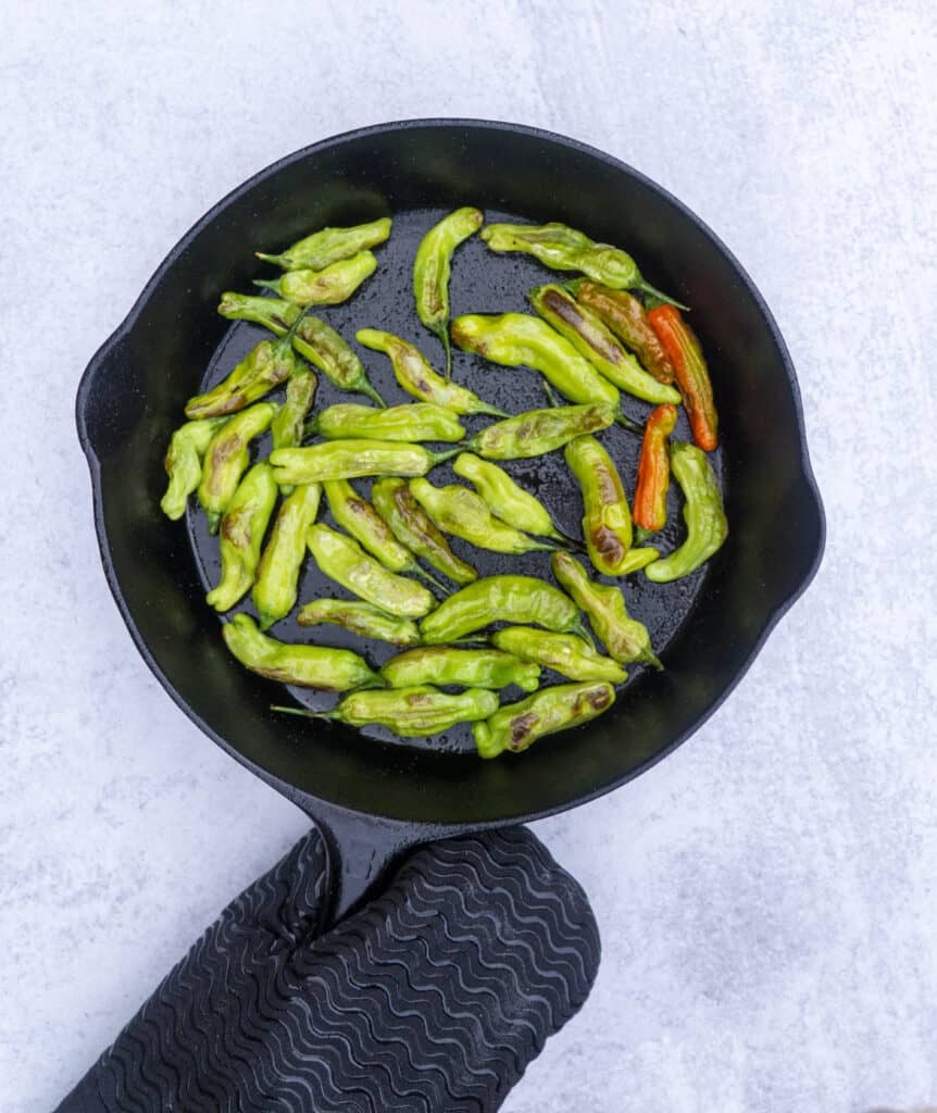 Blistered Shishitos in a cast iron