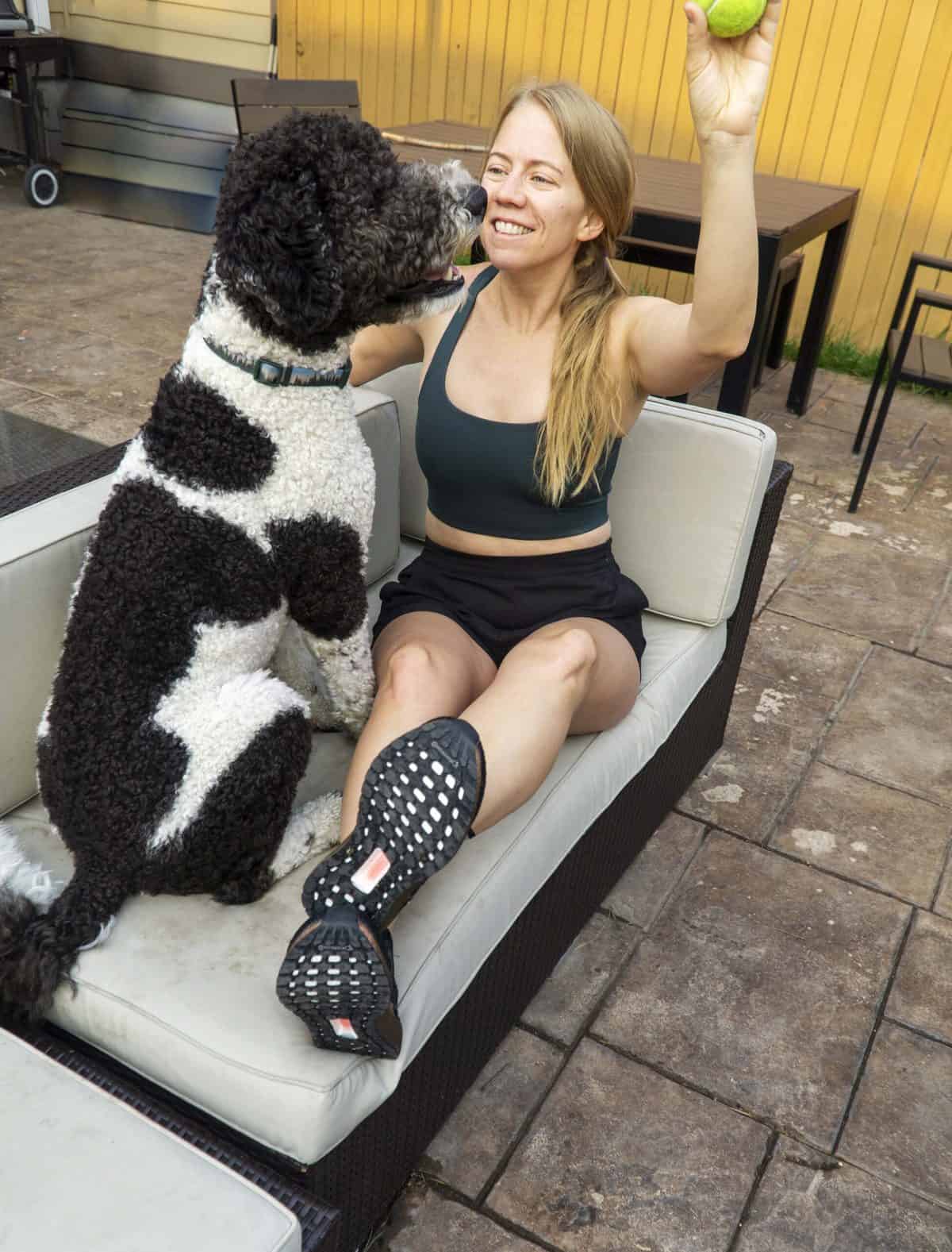 Woman and dog on outside couch
