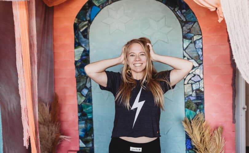 Girl with hands on hair and lightening bowie shirt - feeling energized in front of colorful background